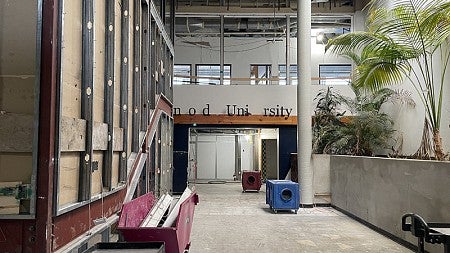 During renovation of the UO Portland Campus Center. This photo shows the main entry of the building. Finishes have been removed in preparation to remove a wall on the left.